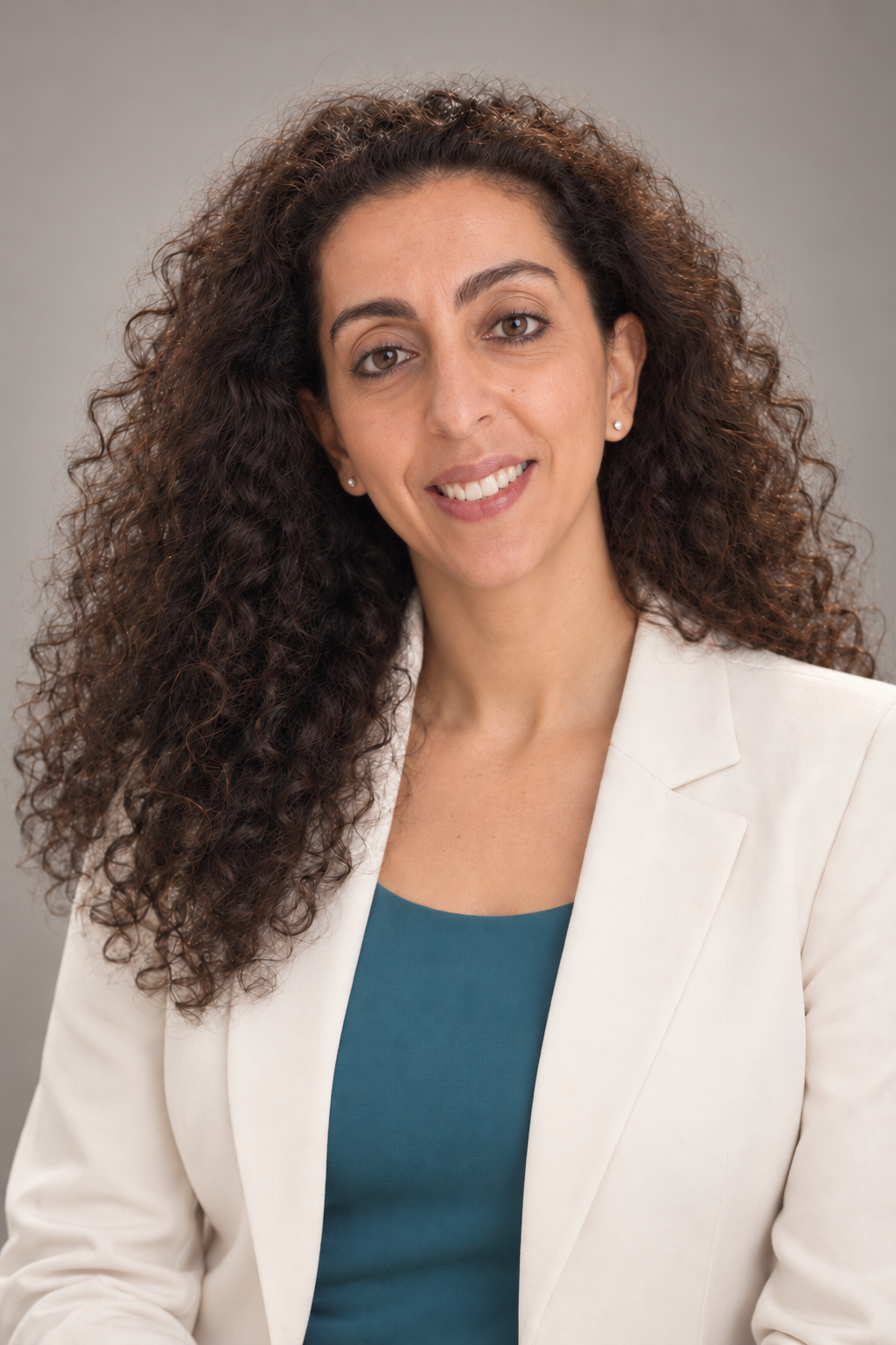 Professional portrait of Sherry Sayari wearing a white blazer